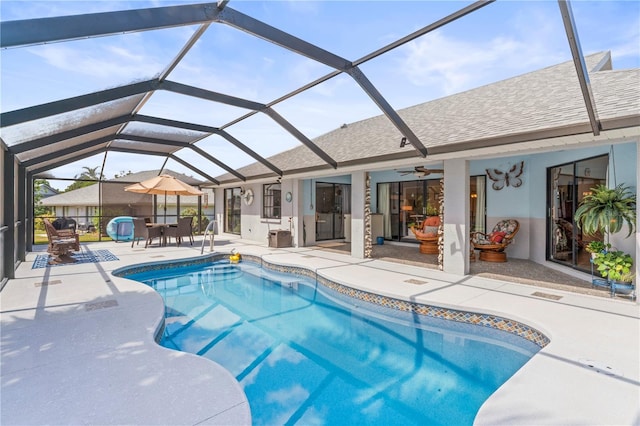 view of swimming pool featuring a lanai, ceiling fan, and a patio