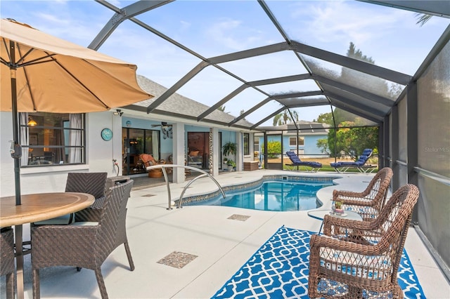 view of pool featuring ceiling fan, a patio area, and a lanai