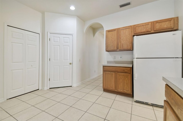 kitchen featuring light tile patterned floors and white fridge