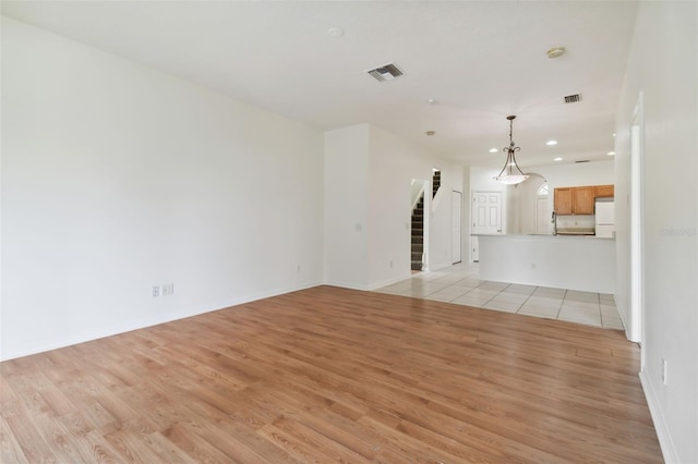 unfurnished living room featuring light hardwood / wood-style flooring