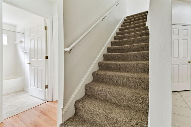 staircase with wood-type flooring