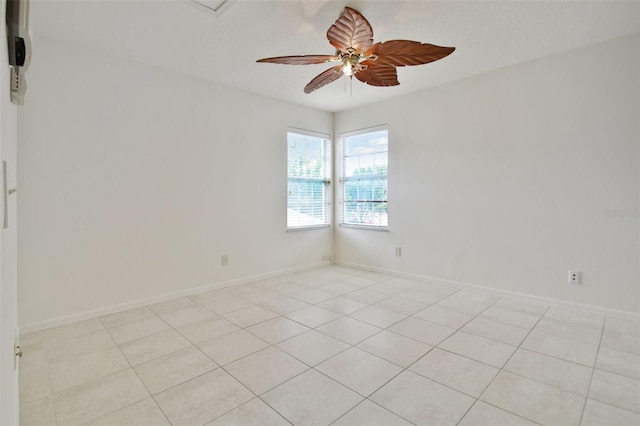 tiled spare room with ceiling fan