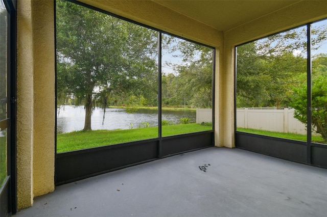 unfurnished sunroom with a water view