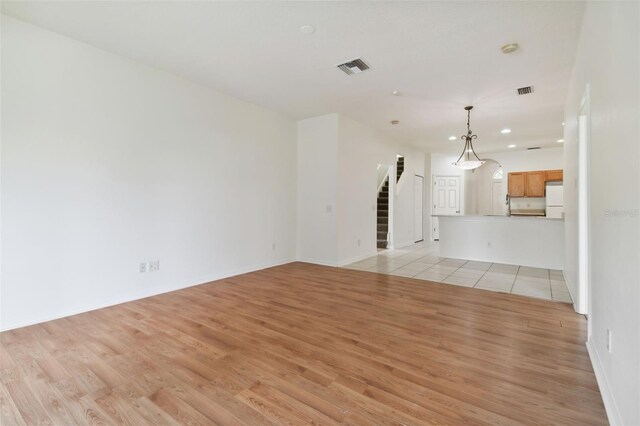 unfurnished living room with light wood-type flooring