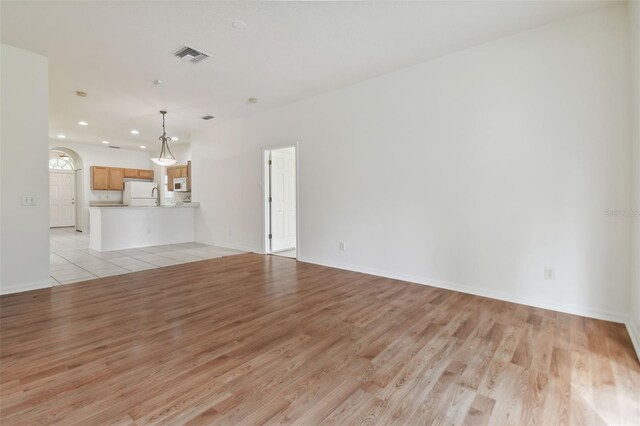 unfurnished living room with light hardwood / wood-style floors