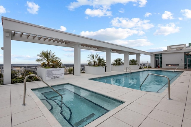 view of pool featuring a patio area and a hot tub