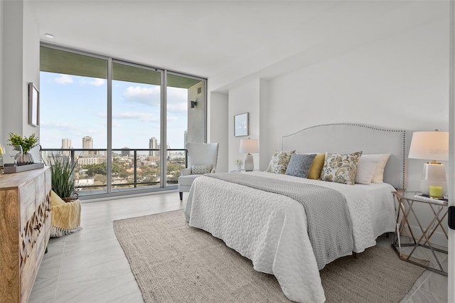 bedroom with access to exterior and a wall of windows