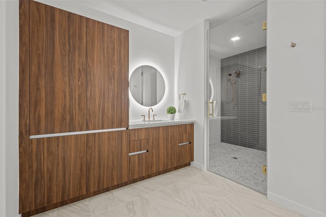 bathroom featuring a shower with door and vanity