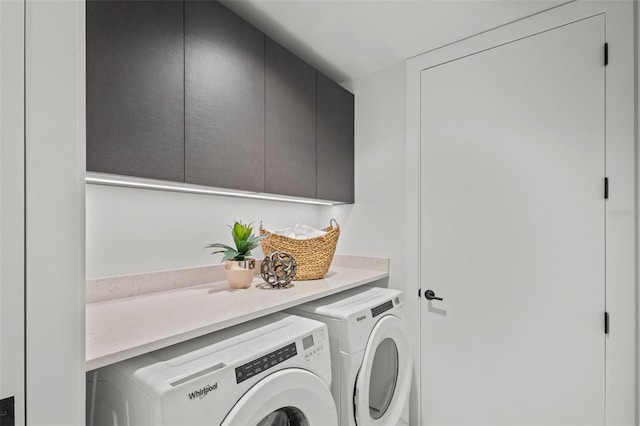 laundry area featuring cabinets and washing machine and clothes dryer