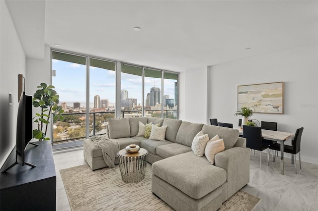 living area featuring a wall of windows, a city view, and baseboards