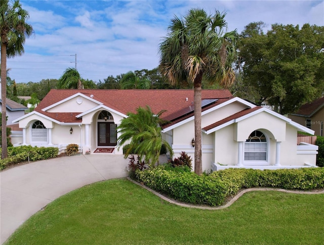 single story home featuring french doors and a front yard