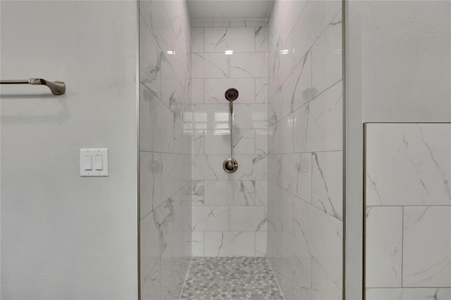 bathroom with tiled shower