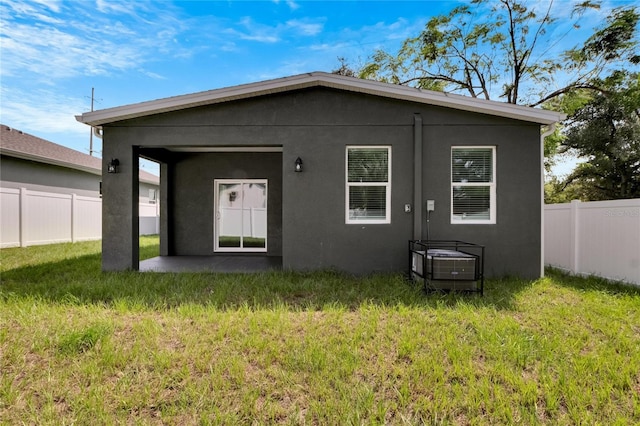 rear view of house with a yard