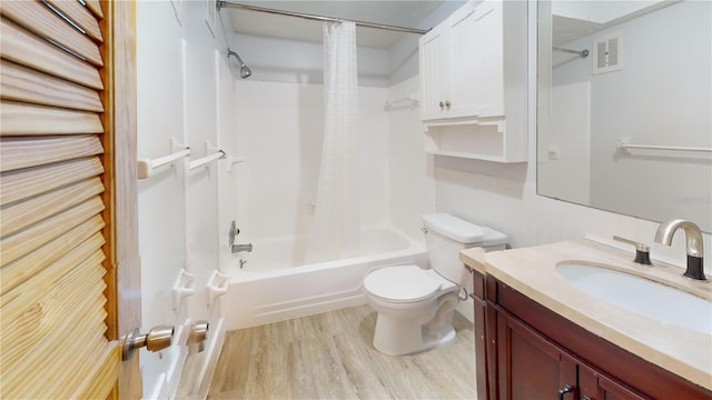 full bathroom with wood-type flooring, vanity, shower / tub combo, and toilet