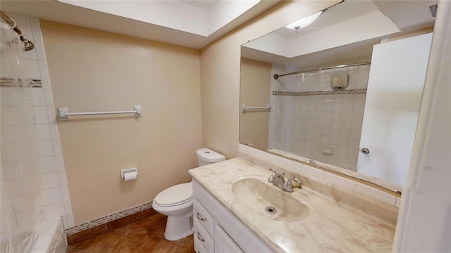 bathroom with tiled shower, vanity, toilet, and tile patterned flooring