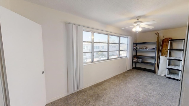 unfurnished bedroom with light carpet, a textured ceiling, and ceiling fan