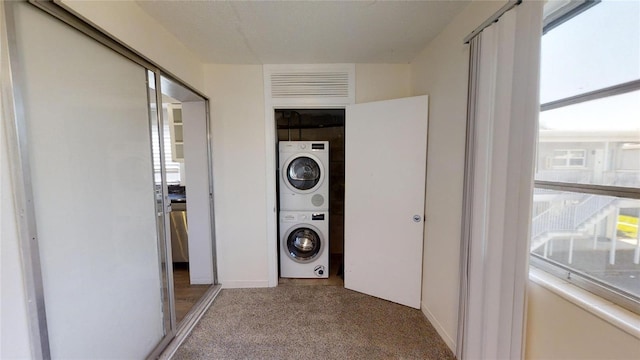 laundry area featuring stacked washer and clothes dryer