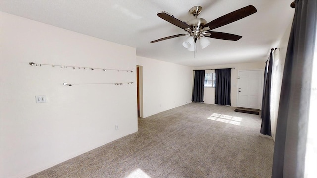 spare room featuring light carpet and ceiling fan