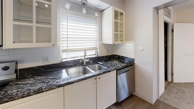 kitchen featuring dishwasher, sink, dark wood-type flooring, dark stone counters, and white cabinets