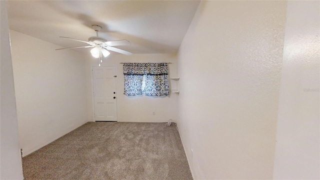 spare room with ceiling fan and light carpet