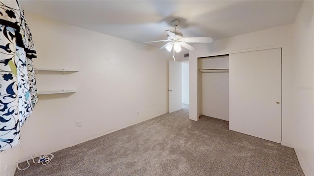 unfurnished bedroom featuring carpet flooring, ceiling fan, and a closet