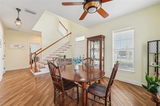 dining area with ceiling fan and hardwood / wood-style floors