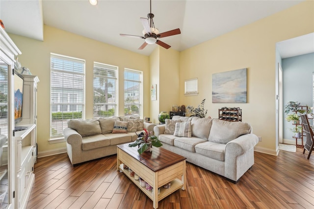 living room featuring ceiling fan and dark hardwood / wood-style floors