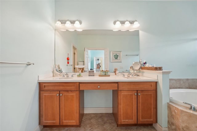 bathroom with tiled tub, vanity, and tile patterned floors