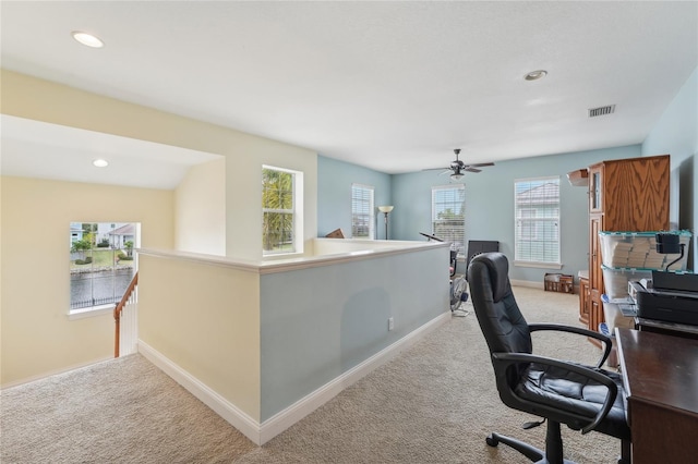 office space with ceiling fan and light colored carpet