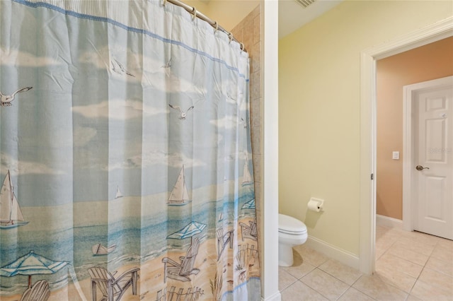 bathroom featuring tile patterned flooring, toilet, and a shower with curtain