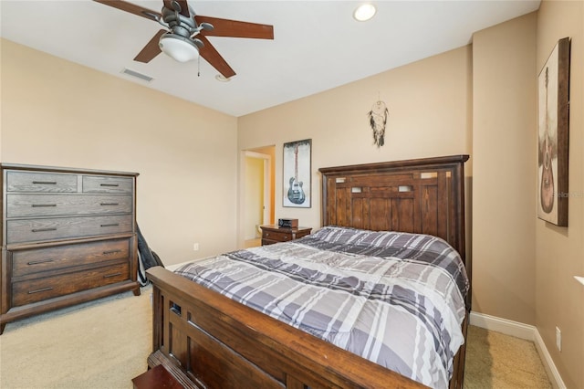 bedroom with ceiling fan and light colored carpet