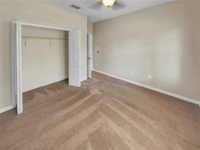 unfurnished bedroom with carpet, ceiling fan, and a closet