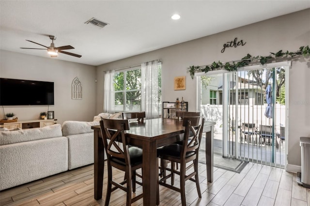 dining space with ceiling fan and light hardwood / wood-style floors