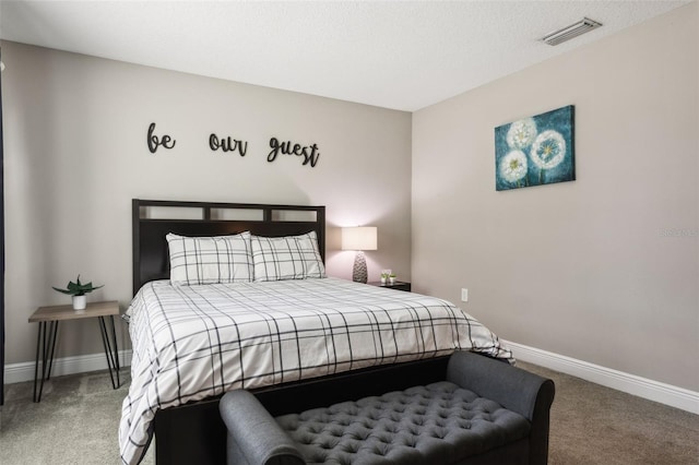 bedroom featuring a textured ceiling and carpet flooring