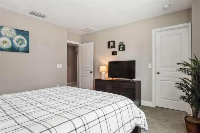 bedroom with light carpet and a textured ceiling