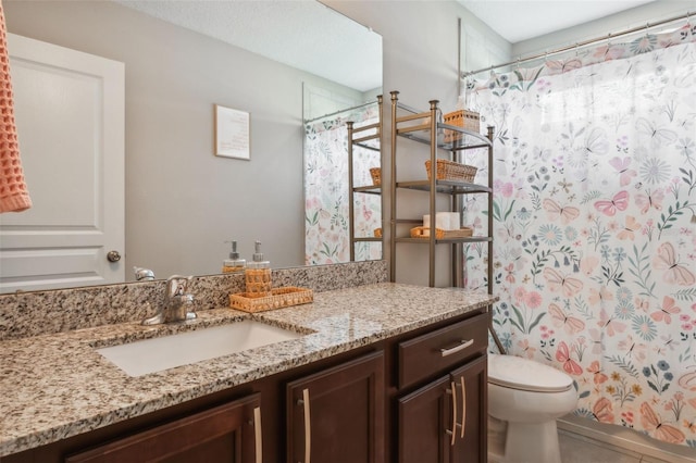 bathroom featuring vanity, toilet, and a shower with shower curtain