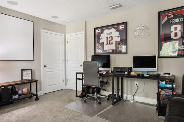 office area featuring a textured ceiling and carpet flooring