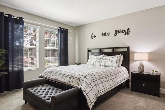 bedroom featuring a textured ceiling and carpet flooring