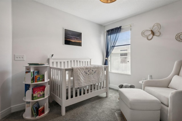 bedroom with a nursery area and carpet