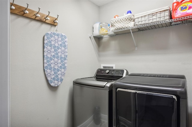 clothes washing area with washer and dryer