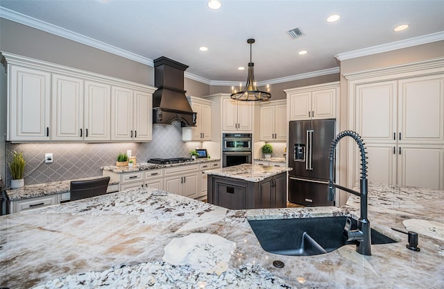 kitchen featuring stainless steel appliances, decorative light fixtures, crown molding, light stone countertops, and premium range hood