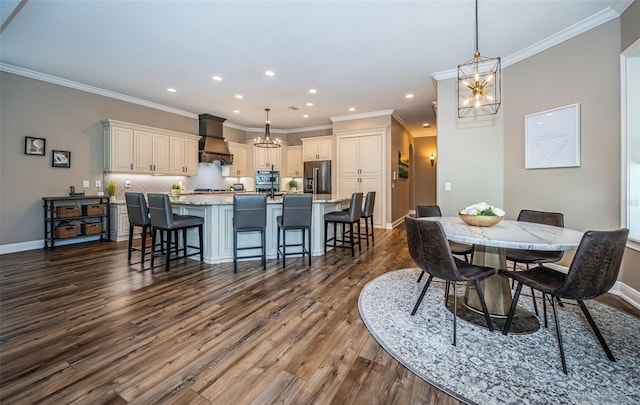 dining space featuring ornamental molding, dark hardwood / wood-style floors, and a chandelier