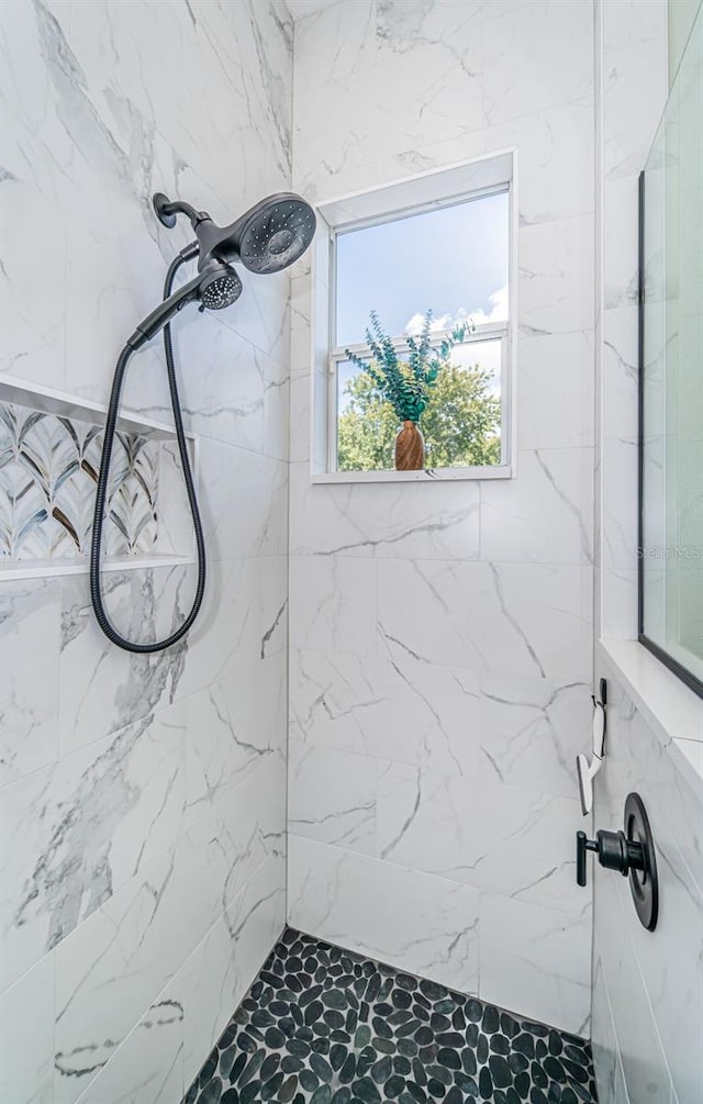 bathroom with a tile shower