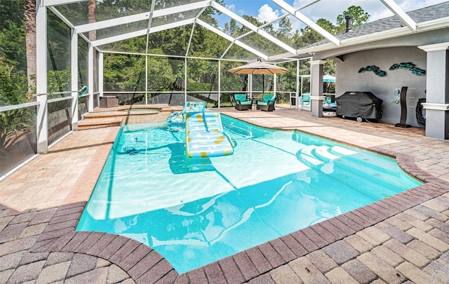 view of swimming pool featuring glass enclosure and a patio