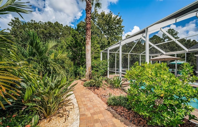 view of yard with glass enclosure