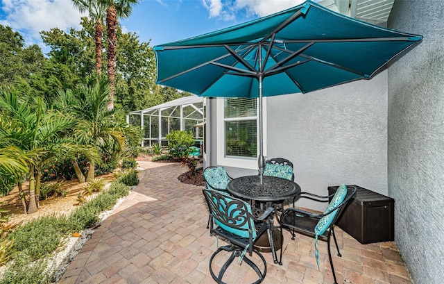 view of patio / terrace featuring glass enclosure