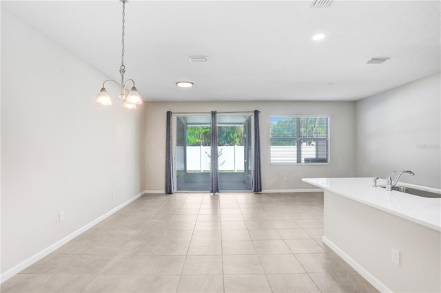 interior space featuring pendant lighting, light tile patterned flooring, a chandelier, and sink