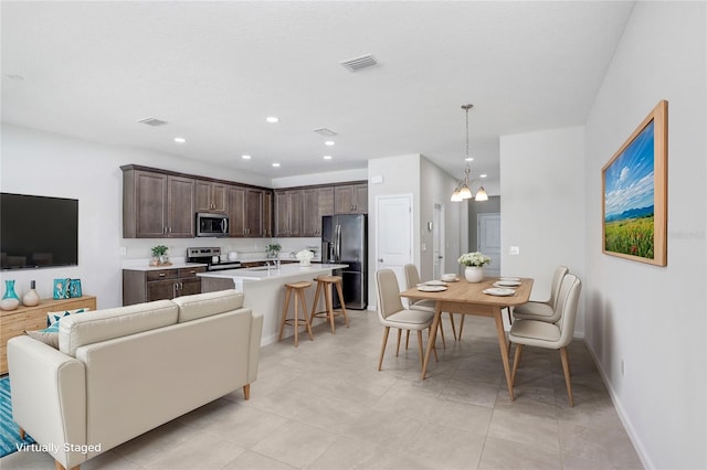 interior space featuring light tile patterned floors and a notable chandelier