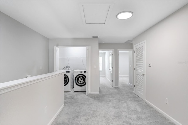 laundry room with light colored carpet and washing machine and dryer