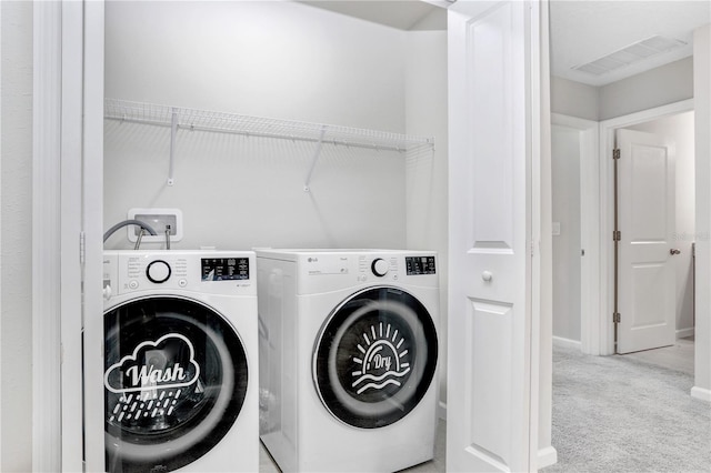 washroom featuring light carpet and washer and dryer